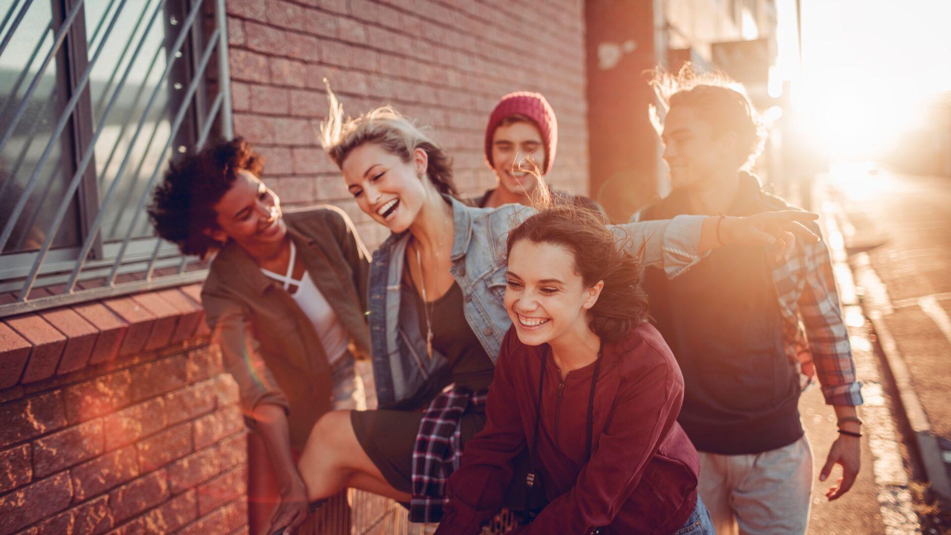 Close up of friends having fun with a shopping cart
