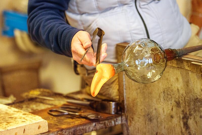 The processing of Murano glass, Venice, Veneto, Italy. A master glassmaker working with the most famous in the world murano glass with fire, crafts in