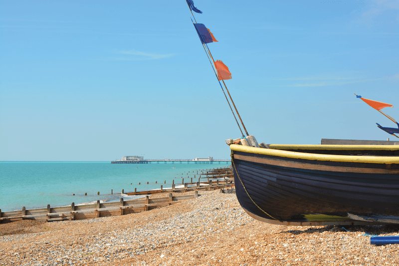 Fishing boats drawn up on the beach at Worthing, West Sussex, England